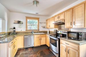 a kitchen with wooden cabinets and stainless steel appliances at Stay Portland - Alberta Arts Luxury, Sleeps 6, Walk Score 99 in Portland