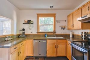 a kitchen with wooden cabinets and stainless steel appliances at Stay Portland - Alberta Arts Luxury, Sleeps 6, Walk Score 99 in Portland
