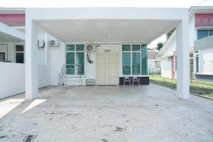a large white house with a large patio at Berkat Juta Homestay 2 in Kuantan
