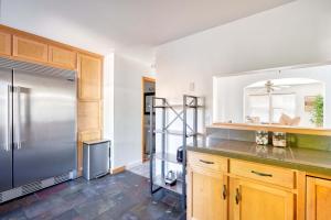 a kitchen with a stainless steel refrigerator and wooden cabinets at Alberta Arts Luxury Sleeps 4 Walk Score 99 in Portland +17 photos