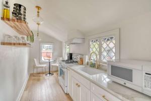 a white kitchen with a sink and a stove at Stay Portland - The Sullivan's Gulch Retreat - 94 Walk Score in Portland