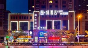 a city at night with lit up buildings at James Joyce Coffetel·Shenyang North Railway Station Shifu Square in Shenyang