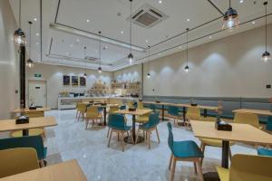 a restaurant with tables and chairs and a cafeteria at City Comfort Inn Guangzhou Tianhe District Tangxia Exhibition Center in Guangzhou