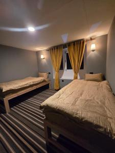 a bedroom with two beds and a window at Highcamp B&B in Namche