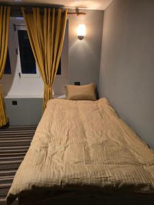 a large bed in a bedroom with a window at Highcamp B&B in Namche
