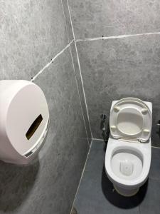 a bathroom with a toilet in a stall at Highcamp B&B in Namche