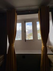 a window with curtains in a room at Highcamp B&B in Namche