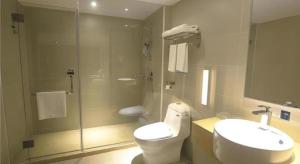 a bathroom with a toilet and a sink and a shower at City Comfort Inn Huizhou Zhongkai Huihuan in Huizhou