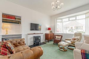 a living room with a couch and a fireplace at Livingstone Crescent - No 5 in St. Andrews