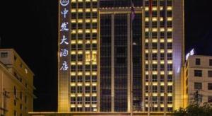 a tall building with lights on it at night at Lavande Hotels· Yueyang Linxiang Zhongfa in Linxiang