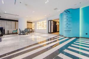 a lobby with a swimming pool and a blue wall at Xana Hotelle Tianjin Binjiang Road Heping Road Metro Station Quanyechang in Tianjin