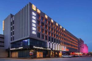 a building with a sign on the side of it at Campanile Hotel Dongying Financial Port in Dongying