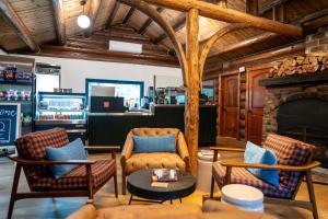 a living room with chairs and a fireplace at Alta Crystal Resort in Greenwater