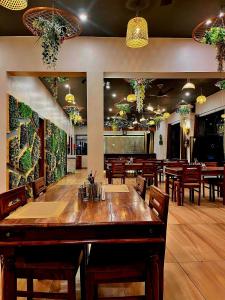 a restaurant with a large wooden table and chairs at Hotel Leela Vilas Pushkar -A Boutique Hotel in Pushkar