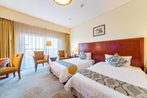 Postel nebo postele na pokoji v ubytování Jinjiang Hotel Qianan + 213 fotografií