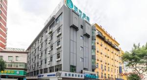 a large gray building with a sign on it at City Comfort Inn Quanzhou Wanda in Quanzhou