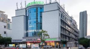 a large building with a sign on top of it at Green Tree Inn Express Fuzhou Three Lanes and Seven Alleys Nanmendou Metro Station in Fuzhou