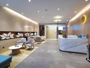 a lobby of a hospital with chairs and a reception desk at GreenTree Inn Luoyang Railway Station Wangfujing Wangcheng Park in Luoyang