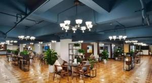 a large room with tables and chairs and potted plants at VX Hotel Chengdu Wenjiang Guosetianxiang Chenyue in Chengdu