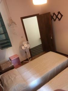 a bedroom with a bed and a door with a fan at Chalet ValNevera in Primolano