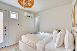a white bedroom with a bed and a couch at Stay Portland - Alberta Arts District Hideaway - Stylish Studio in Portland