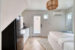 a kitchen with a refrigerator and a bed in a room at Stay Portland - Alberta Arts District Hideaway - Stylish Studio in Portland