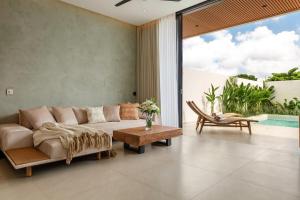 a living room with a couch and a table at Sunset Bliss Villa with Private Pool-North Canggu in Dalung