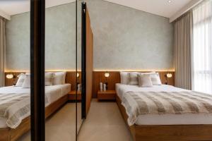 a bedroom with two beds and a glass wall at Sunset Bliss Villa with Private Pool-North Canggu in Dalung