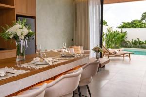 a dining room with a table and chairs at Sunset Bliss Villa with Private Pool-North Canggu in Dalung
