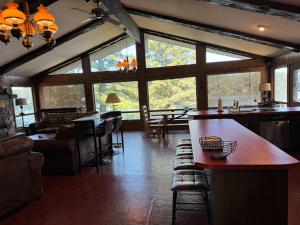 a kitchen and living room with large windows at Private 6-Bdrm Lodge on 1000ft Sandy Lakeshore in Round Lake Seaplane Base +69 photos