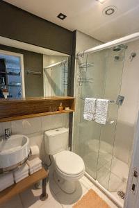 a bathroom with a toilet and a shower and a sink at Brás Downtown Residence Flat in Sao Paulo