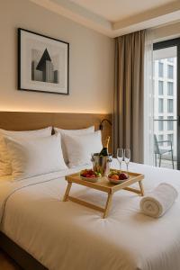 a hotel room with a bed with a tray of fruit on it at Brás Downtown Residence Flat in Sao Paulo