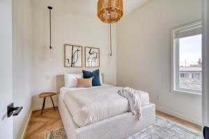 a white bedroom with a bed and a window at Stay Portland - Alberta Arts District Hideaway - Stylish Townhome in Portland