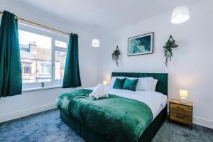 a bedroom with a bed and a large window at 3 BR House By By Eason Stays Short Lets & Serviced Accommodation Sheffield With Pool Table & Free Parking in Nether Edge