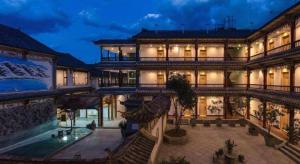 a large building with a courtyard at night at Vienna Hotel Yunnan Dali Ancient City Scenic Spot in Dali Ancient Town