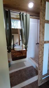 a bathroom with a sink and a mirror at Moana at Teahupo'o in Teahupoo