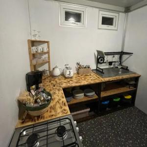 a kitchen with a counter with a sink and a stove at Moana at Teahupo'o in Teahupoo