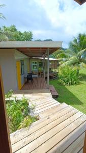 a porch of a house with a wooden deck at Moana at Teahupo'o in Teahupoo