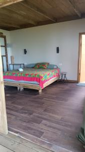 a bedroom with a large bed in a room at Moana at Teahupo'o in Teahupoo +12 photos