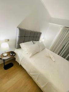 a bedroom with a large white bed and a table at San Miguel Apartment Ocean Magic in Lima