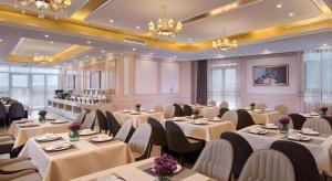 a dining room with tables and chairs and chandeliers at Vienna Hotel Xuzhou Junsheng Plaza Benteng Avenue Metro Station in Xuzhou