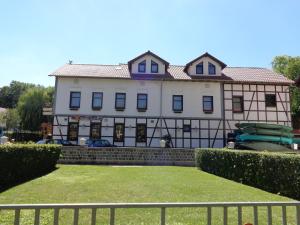 um grande edifício branco com uma cerca em frente em Landhotel zur guten Quelle em Eisenach