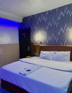 Postel nebo postele na pokoji v ubytování PnK Inn