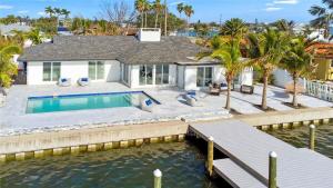 an aerial view of a house with a swimming pool at Waterfront l Private Pool l Dock l Sunset Views in St Petersburg
