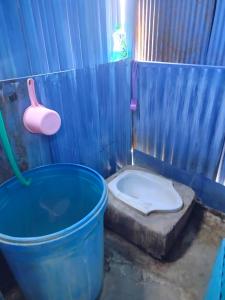 a bathroom with a tub and a toilet with a bucket at Atta komodo homestay in Komodo +22 photos