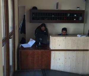 two people sitting at a desk with a computer at Valle Nevado Apartamento Ski In Out in Valle Nevado