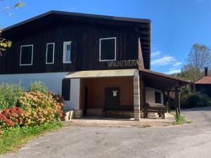 a building with a bench in front of it at Chalet ValNevera in Primolano +4 photos