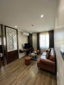 a living room with a couch and a table at Khách Sạn Á Châu in Trại Khao