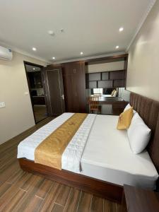 a bedroom with a large bed in a room at Khách Sạn Á Châu in Trại Khao +23 photos