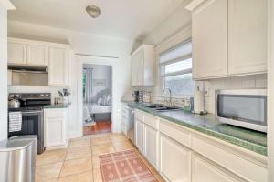 a kitchen with white cabinets and a microwave at Cute & Comfortable Portland Home with 91 WalkScore in Portland